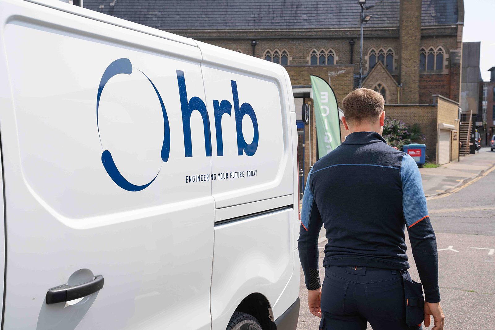 An HRB engineer walking back to the HRB van on a residential street