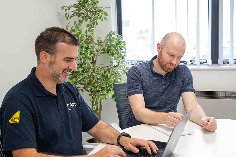 An HRB engineer working through a heat pump design with a colleague